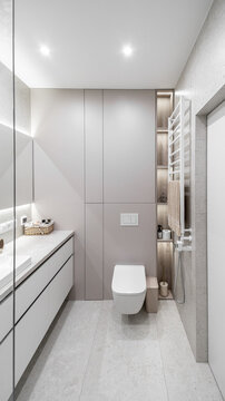 white bright bathroom. toilet and cabinets, heated towel rail, lighting. stylish designer expensive renovation, apartment, hotel room.