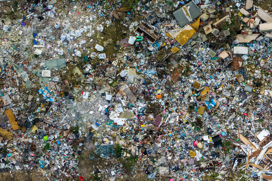 Aerial view of an illegal landfill site with scattered household waste, plastic debris, and discarded furniture in Belgrade, Serbia.