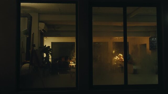 Cozy Evening Dinner Gathering Seen Through a Window at Night