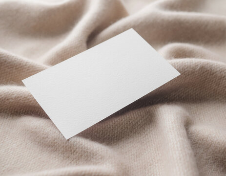 White business card mockup template on soft beige fabric