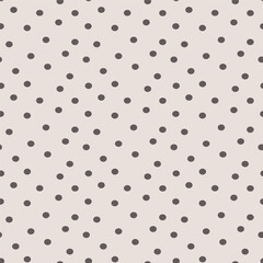 Soft beige background with scattered dark grey polka dots in a simple seamless pattern © SA Graphic Desing