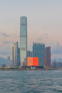 M+ Museum LED facade with ICC tower and West Kowloon skyline at dusk