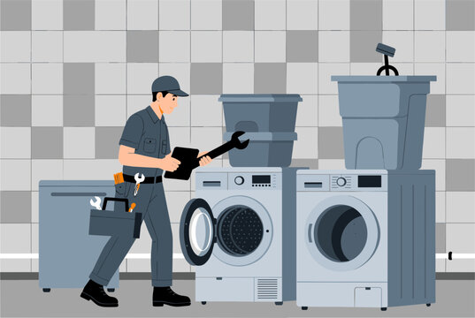 Professional appliance technician in uniform holding a wrench and examining washing machines in a modern laundry room.