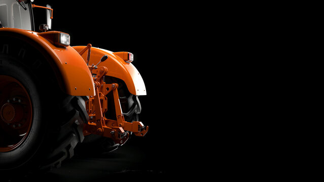 Rear view of orange tractor on black background. Close-up of heavy agricultural machinery and mechanical hitch system. Modern farming equipment concept for industrial design and agribusiness.