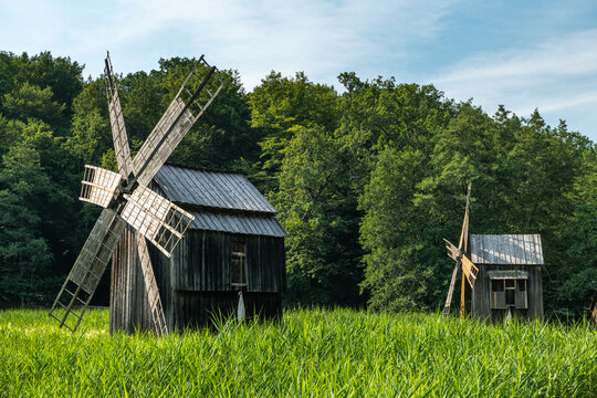 Wooden Windmill in Rural Farm Landscape