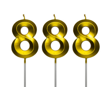 Number eight hundred eighty eight shaped golden metallic birthday candles isolated on a white background