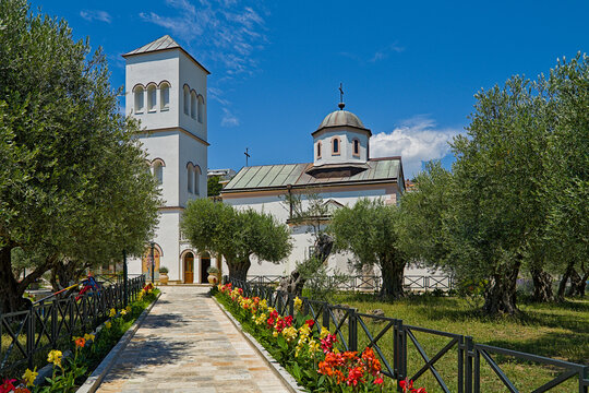 St. Nicholas Church in Ulcinj, Montenegro, with olive trees and colorful flowers