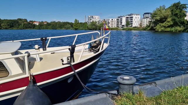bMotorboat moored beside a lakeside bollard on Zegelinnensee in Schwerin, Germany