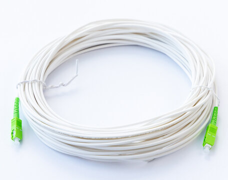 White Fiber Optic Cable Coil with Green Connectors on White Background