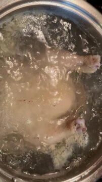 the chicken is cooking in boiling water