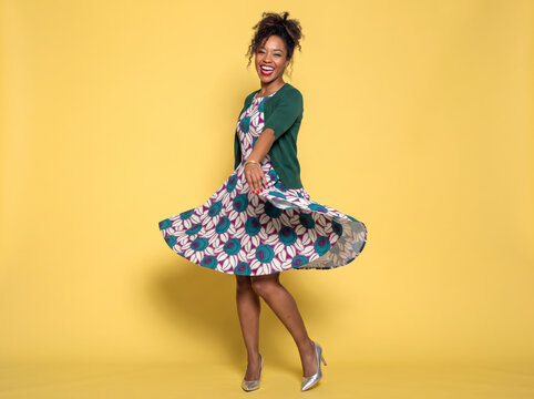 Black girl in a dress dancing