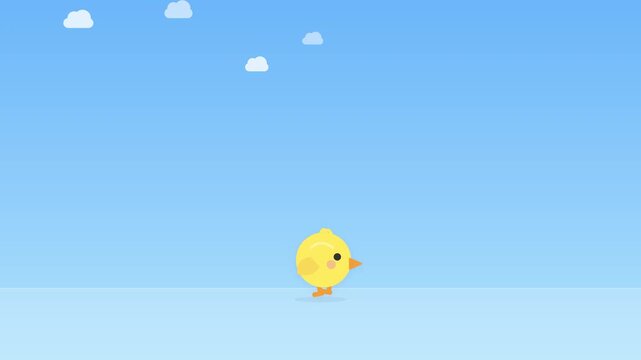 Yellow chick against a clear blue sky