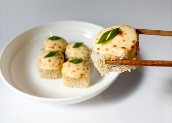 Beautifully arranged assorted sushi on a white plate © Polina_mrtnk