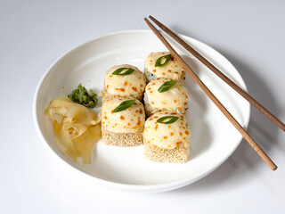 Beautifully arranged assorted sushi on a white plate © Polina_mrtnk