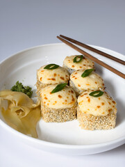 Beautifully arranged assorted sushi on a white plate © Polina_mrtnk
