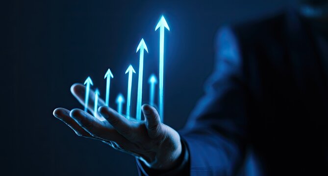 Hand holding glowing upward arrows representing growth and success