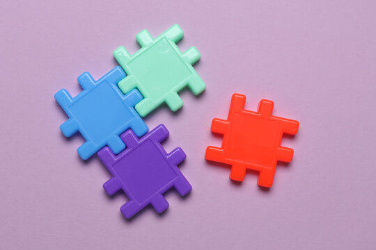 Children's plastic construction set, puzzles on purple background