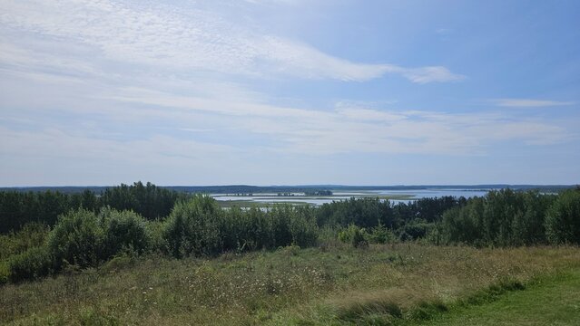 Scenic lake view under blue sky with fluffy clouds during daytime