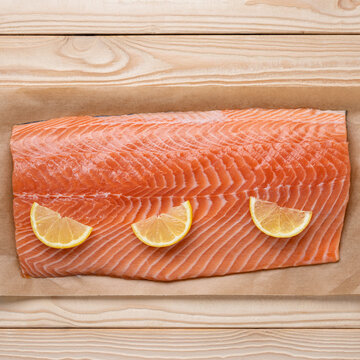 Salmon fillet with lemon slices square healthy fresh food background