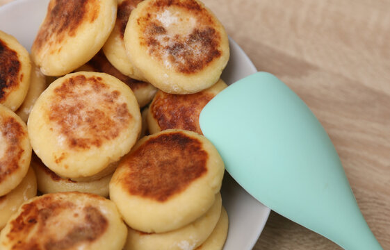 Homemade delicious syrniki, cheese pancakes in a plate on the table