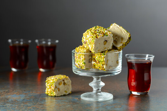 Turkish delights with black tea on a dark  background.