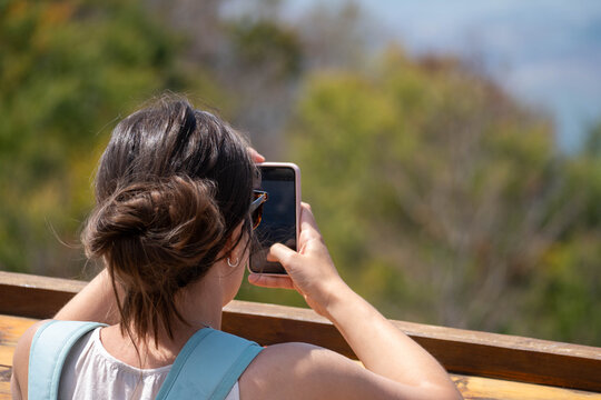 Female Tourist Using Smartphone at Scenic Mountain Viewpoint, Travel Navigation and Mobile Photography During Summer Vacation
