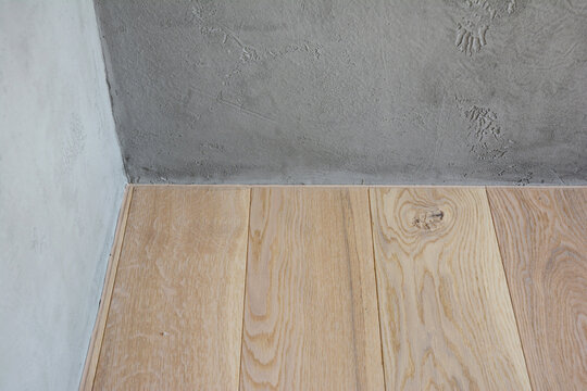 Wooden flooring without baseboard in interior