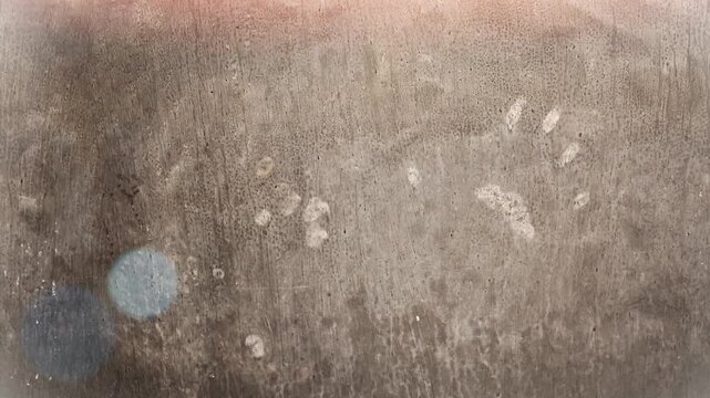 Seamless 4K looping vertical movement across a worn concrete wall with subtle stains and natural surface texture. Perfect for industrial backgrounds motion graphics and creative design.