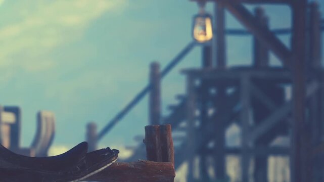 A wooden structure stands tall with a lantern hanging above. A shoe rests on a post in the foreground. The scene shows a rustic atmosphere likely in a countryside location.