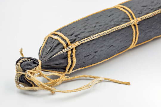 Traditional cured horse meat sausage in dark casing, closeup.