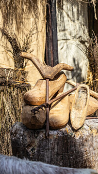 Traditional wooden clogs and rustic carpentry tools