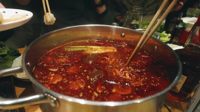 Slow Motion Chinese Hot Pot Gathering Friends and Family Dipping Meat