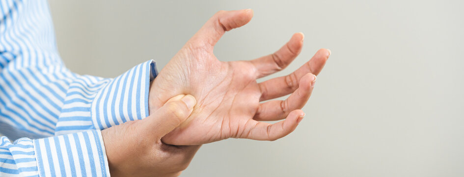 Health care and medical concept, rheumatism asian woman hand pain from cramp, trigger finger, wrist pain touching massaging, hand holding ache joint, arthritis inflammation.Chronic disease from injury