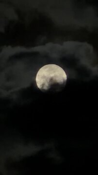 The full moon night among the dark cloudy sky. Full Moon phase (traditionally called the Wolf Moon. 3 Jan, 2026.  Thailand.