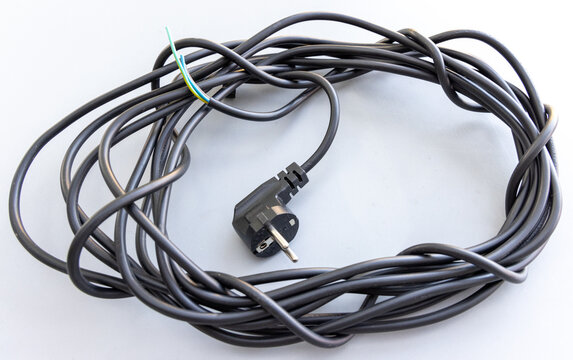 Coiled black electrical cable with a European plug and exposed wires