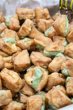 Fried tofu stuffed with a mixture of tapioca flour and green onions commonly known as tahu isi aci features a crispy exterior and a soft, chewy.