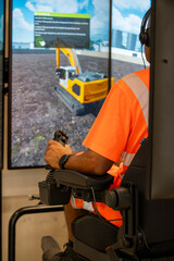 Excavator operator training on construction equipment simulator with joystick controls © Pascal