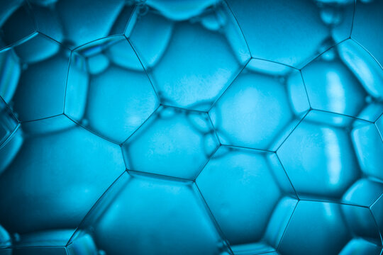 Abstract macro background of blue soap bubbles forming hexagonal pattern, science technology and connectivity concept