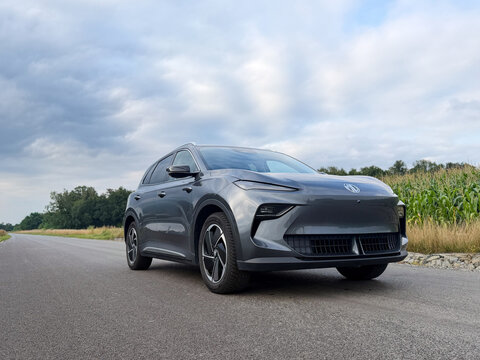 Gray suv parked on a quiet country road with cloudy sky, open landscape, and fields in the background MG S5 EV electric Poland, Pszczyna, 3.08.2026 

