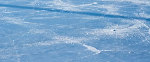 Fototapeta premium Closeup of ice skating rink surface with skate marks