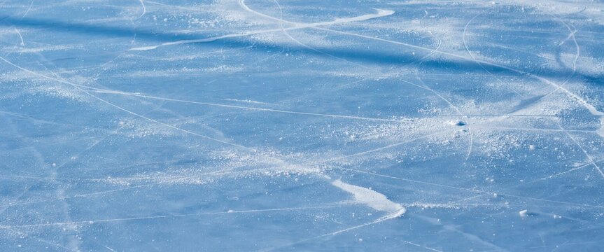 Closeup of ice skating rink surface with skate marks