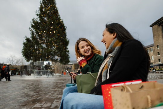 Friends laughing during christmas shopping at Granary Square