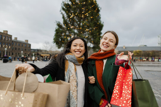 Friends enjoying Christmas shopping in London market