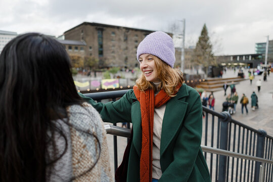 Smiling young women enjoying winter walk in London