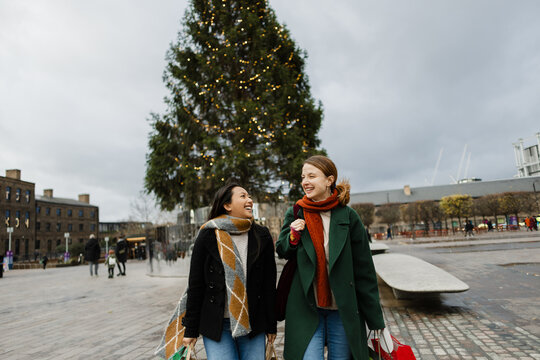 Friends enjoying festive Christmas shopping at market