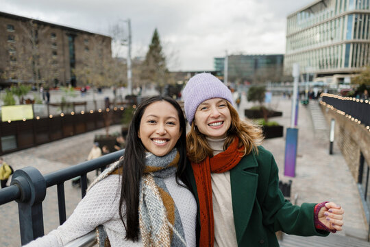 Smiling young women enjoying winter in London