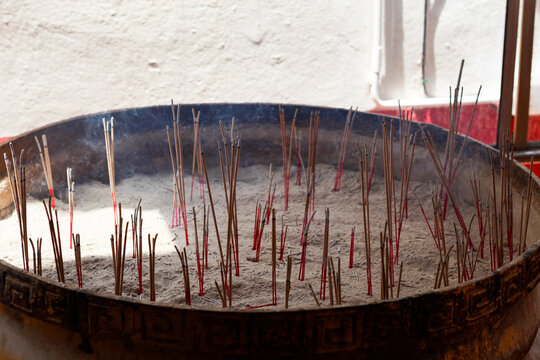 Burning Incense Sticks in an Incense Bowl at a Buddhist Temple