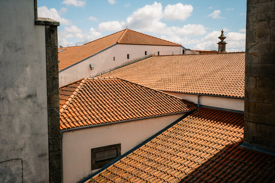 View of Tiled Roofs in a Town Under Blue Sky With Clouds