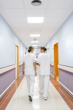 Nurses walking together in hospital corridor
