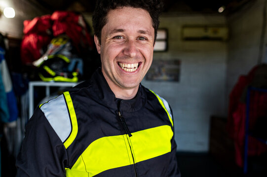 Relaxed kart racer laughing in track garage
